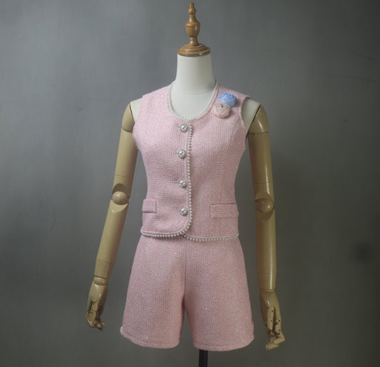 Front view of a custom pink tweed shorts suit with pearl trim, featuring a sleeveless vest and high-waisted shorts, worn as a summer outfit for plus size women – ideal for graduation, weddings, or smart casual events.
