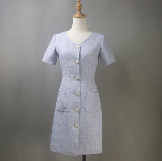Front view of bespoke summer blue tweed dress on mannequin, V-neck design, tailored fit, short/long length option, ideal for weddings and formal events