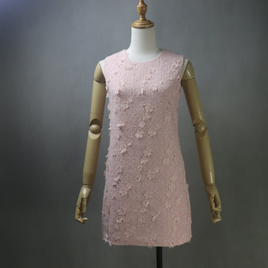 Pink tweed dress on a mannequin against a gray background