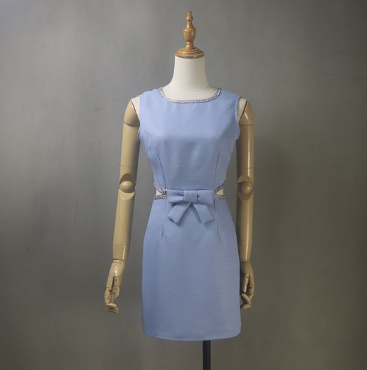 Designed for the confident woman who loves to stand out, this dress features a flattering deep V back cut-out, an elegant bow detail, and your choice of mini or midi length. Crafted from high-quality textured blue tweed, it offers a chic blend of structure and softness – perfect for daytime glamour or evening sophistication.