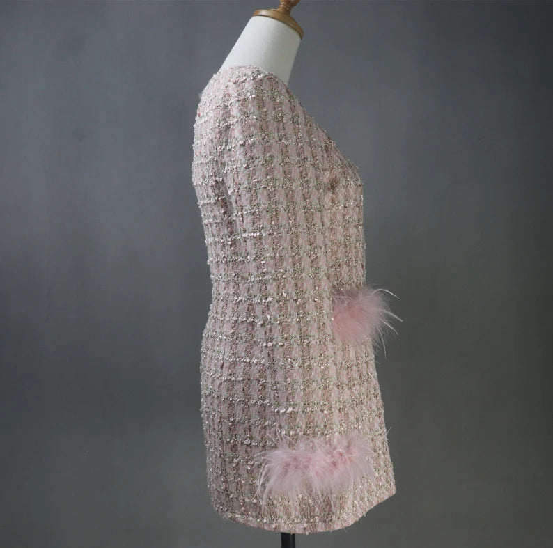 With our custom-made Faux Fur Cuffs Tweed Long Coat in a delicate shade of light pink, you may indulge in classic elegance that is ideal for your most important events. This gorgeous coat is expertly made to add to the allure of formal events, graduations, and wedding ceremonies. The opulent imitation fur cuffs lend an air of refinement, which makes it the perfect option for an evening coat that exudes elegance and grace.