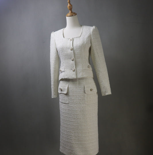 Front view of a custom-made Beige tweed jacket and midi skirt suit. The jacket features a square neckline and subtle bubble sleeves, paired with a matching high-waisted midi skirt. The textured tweed fabric adds elegant structure and softness to the look.