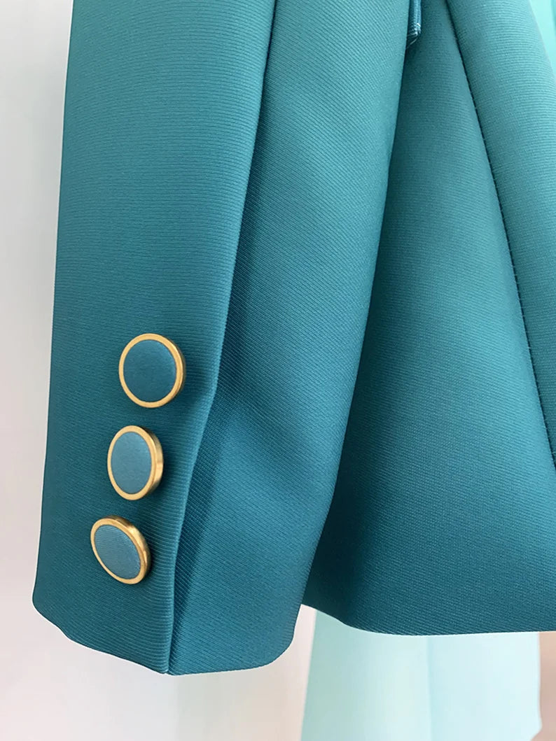 The blazer is the centerpiece of this ensemble, exuding luxury and style. It's meticulously crafted from a rich, emerald green fabric that seamlessly transitions into a subtle gradient, fading into a slightly lighter shade towards the bottom. The luxurious material drapes elegantly, giving the blazer a fluid and sophisticated appearance. The tailored fit ensures it flatters your figure, with structured shoulders and a cinched waist to accentuate your curves.
