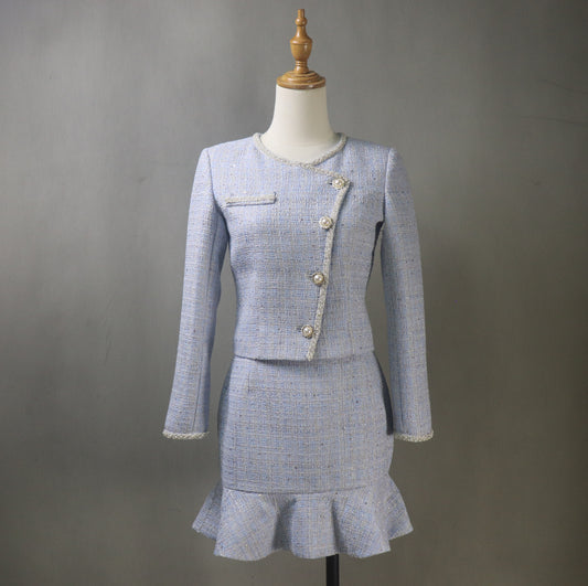 Front view of bespoke light blue tweed women's skirt suit on mannequin – fitted jacket and fishtail skirt, formal outfit for graduation or wedding guest