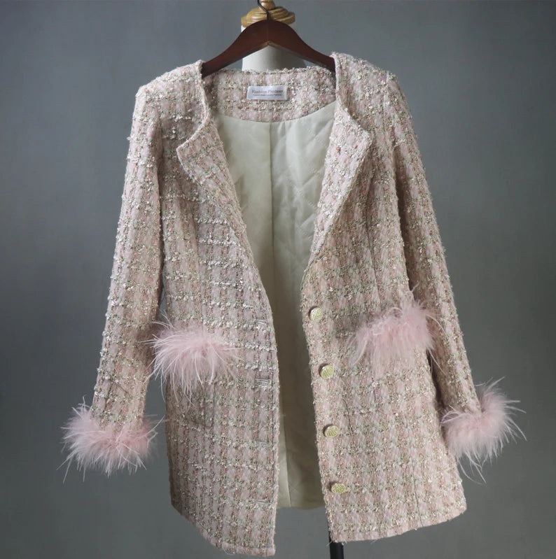 With our custom-made Faux Fur Cuffs Tweed Long Coat in a delicate shade of light pink, you may indulge in classic elegance that is ideal for your most important events. This gorgeous coat is expertly made to add to the allure of formal events, graduations, and wedding ceremonies. The opulent imitation fur cuffs lend an air of refinement, which makes it the perfect option for an evening coat that exudes elegance and grace.