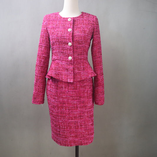 Pink tweed skirt suit on a mannequin against a gray background