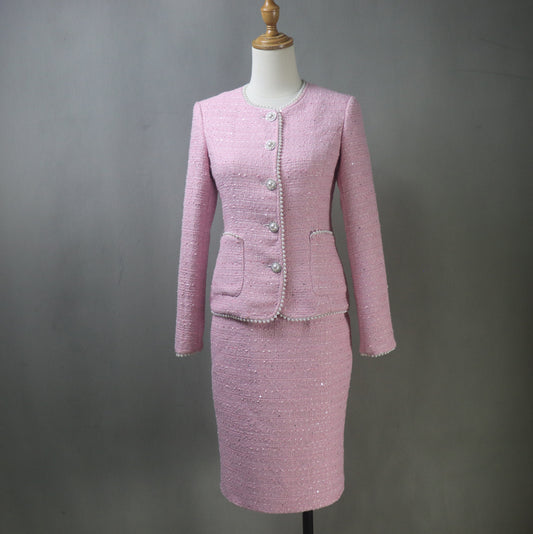 Front view of bespoke light pink tweed skirt suit with pearl details on mannequin – long pencil skirt and pearl-trimmed blazer for weddings, graduations, and formal events