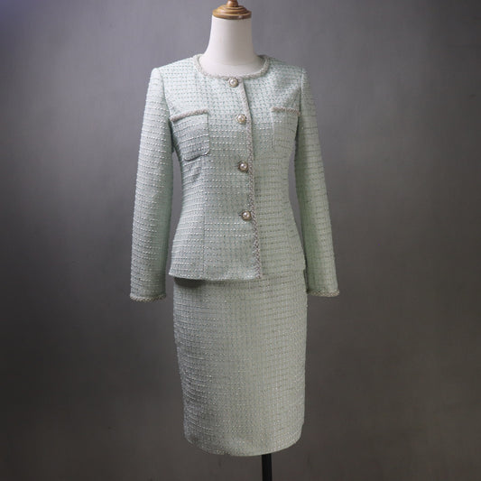 Green tweed suit on a mannequin against a gray background