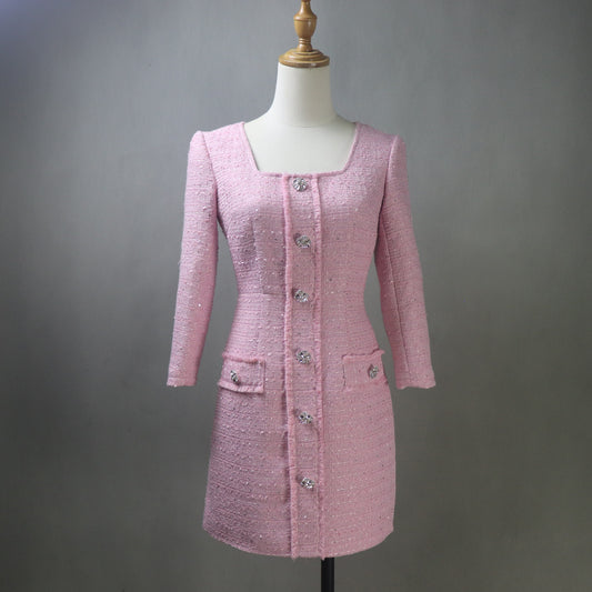 Pink tweed dress on a mannequin against a gray background