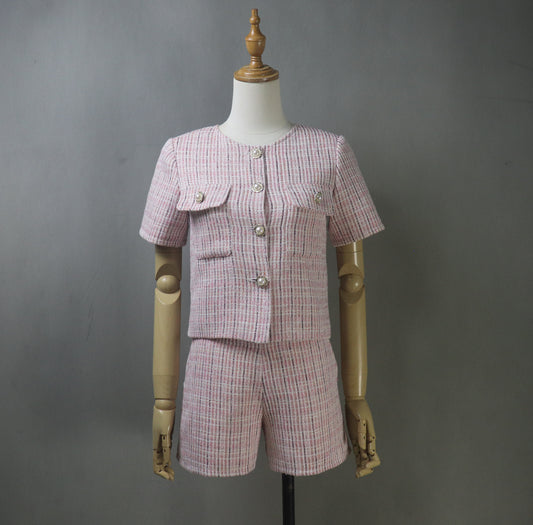 Front view of mannequin wearing custom-made pink tweed suit with short-sleeved blazer and matching high-waisted shorts, styled for summer.