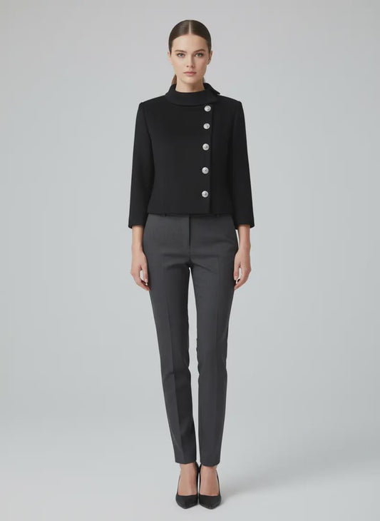 Close-up of a custom-made black cropped wool jacket for women, featuring a structured Nehru collar and five ornate silver buttons in a side-closure military style on a mannequin.