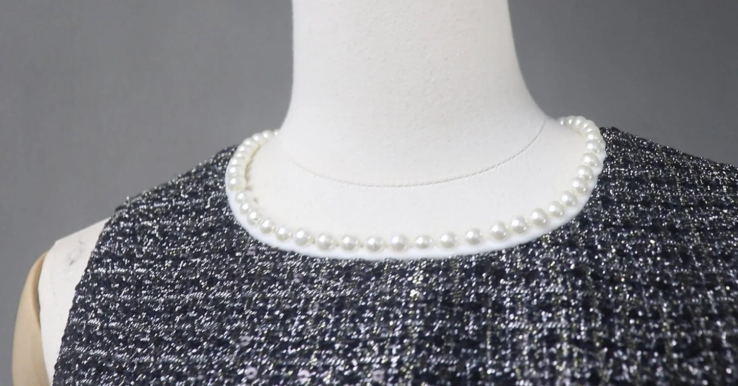 This dazzling FASHION Sequinned tweed little dress will stun everyone with its glamorous notes! This slim-fit black dress is made of a mid-weight tweed with dazzling lame accents, small sequins with white chiffon trims, and is lined with black satin. This dress also has a high neckline with trims, a sleeveless design,