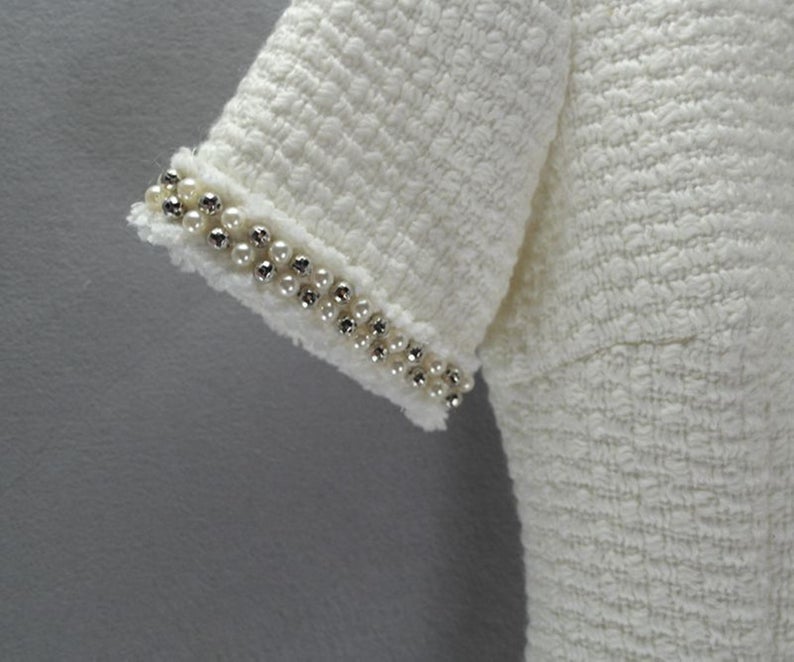 Womens Custom Made Pearls White WOOL Tweed DressSheath Custom Made Pearls White WOOL Tweed Dress UK CUSTOMER SERVICE! Sheath Custom Made Pearls White WOOL Tweed Dress - Round neck and arm with gold and pearl button designed. Knee Length Sheath Dress. Our tailor will make sharp body measurement and look perfect fit. You will love this casual sheath dress! It's a must-have piece in your wardrobe with its simple silhouette and slight A-line shape.