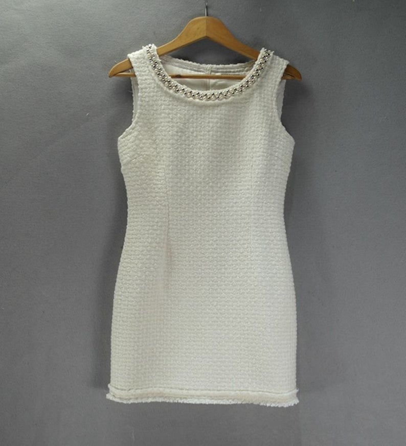 Sheath Custom Made Pearls White WOOL Tweed Dress UK CUSTOMER SERVICE! Sheath Custom Made Pearls White WOOL Tweed Dress - Round neck and arm with gold and pearl button designed. Knee Length Sheath Dress. Our tailor will make sharp body measurement and look perfect fit. You will love this casual sheath dress! It's a must-have piece in your wardrobe with its simple silhouette and slight A-line shape.