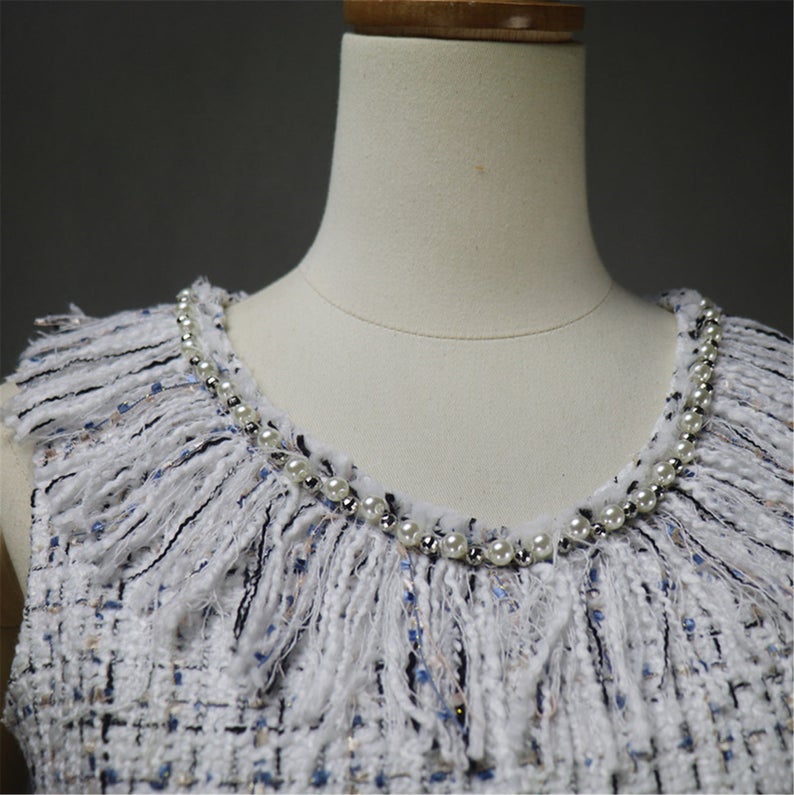 Women's Designer Inspired Custom Made Pearls Decoration Tassel Fringe Tweed Sheath Dress UK CUSTOMER SERVICE! Women's Designer Inspired Custom Made Pearls Decoration Tassel Fringe Tweed Sheath Dress - Custom made Tassel Fringe is modified as per customer requirement. Back zip closure , pearl Jewel neck, Short sleeves, Lined , 70% polyester, 24% acrylic, 3% wool, 3% other fibres. Dry clean.