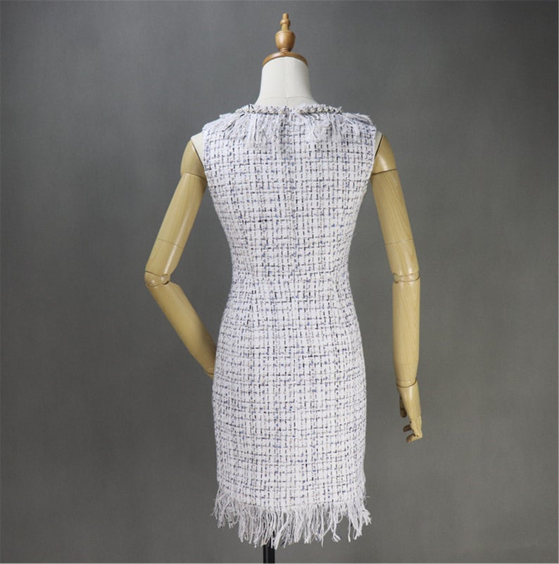 Women's Designer Inspired Custom Made Pearls Decoration Tassel Fringe Tweed Sheath Dress UK CUSTOMER SERVICE! Women's Designer Inspired Custom Made Pearls Decoration Tassel Fringe Tweed Sheath Dress - Custom made Tassel Fringe is modified as per customer requirement. Back zip closure , pearl Jewel neck, Short sleeves, Lined , 70% polyester, 24% acrylic, 3% wool, 3% other fibres. Dry clean.