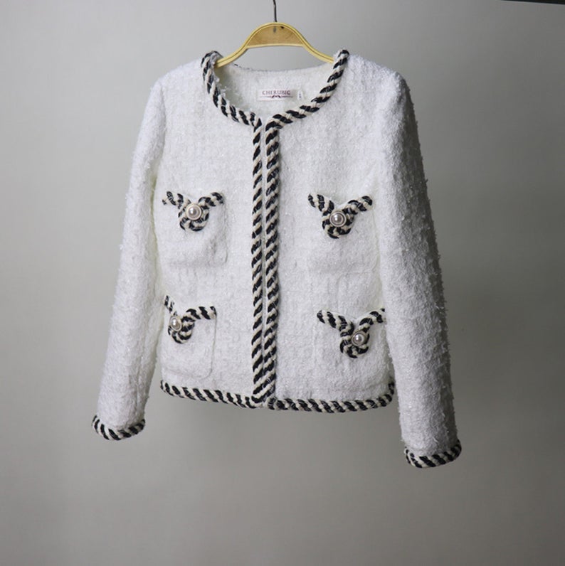White Pearl Button Tweed Jacket Coat Women's Blazer UK CUSTOMER SERVICE! White Pearl Button Tweed Jacket Coat Women's Blazer - Pearl buttons with four front pockets. Tweed fabric with round neck and long sleeves. Dry clean.*Customized Size* All items are made to order. Please advise your height, weight and body measurements ( Bust, shoulder, Sleeves, Waist and Length etc). Our tailors will make the order for you! Materials: Wool blend