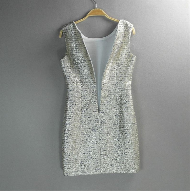 Step your way into any party this holiday season with their sliver Sparkly. Style with heels and a mini bag to complete the look. Fully lined ,front pocket and front pocket. This sleeveless silver sparkle dress is perfect matched with beautiful handbag or purse. Festive fashion at it s finest.