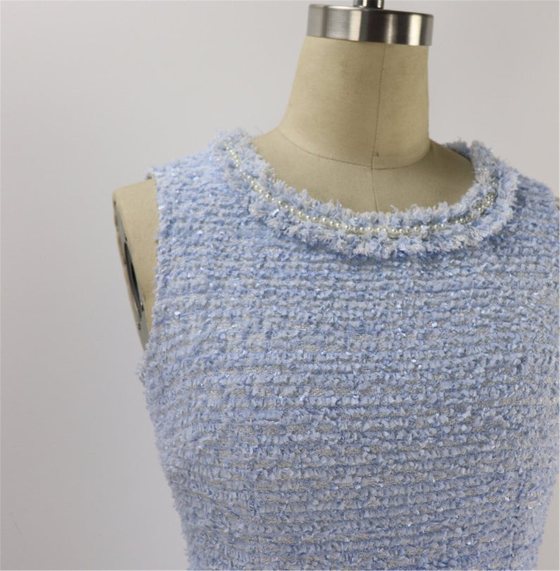 Tweed Sheath Dress Light Blue For Womens Custom Made UK CUSTOMER SERVICE! Tweed Sheath Dress Light Blue For Women's Custom Made - Round Neck with two pockets and Sleeveless. Fastening back zipper and Fringe detail. All items are made to order. Please advise your height, weight and body measurements ( Bust, shoulder, Sleeves, Waist and Length etc). Our tailors will make the order for you! Materials: Wool blend