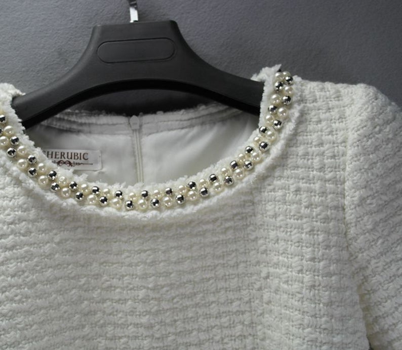 Sheath Custom Made Pearls White WOOL Tweed Dress UK CUSTOMER SERVICE! Sheath Custom Made Pearls White WOOL Tweed Dress - Round neck and arm with gold and pearl button designed. Knee Length Sheath Dress. Our tailor will make sharp body measurement and look perfect fit. You will love this casual sheath dress! It's a must-have piece in your wardrobe with its simple silhouette and slight A-line shape.