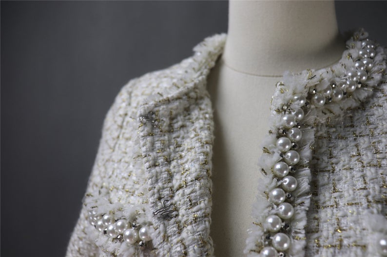 Tweed Pearls Sparkle Thread Blazer + Skirt Suit UK CUSTOMER SERVICE! Tweed Pearls Sparkle Thread Blazer + Skirt Suit - Fashion elements combine classic design. Great for teens or some young ladies dressing the classic, retro, casual and stylish look. Dress designed with pearl buttons , round neck and little tassel. This can be worn all suitable occasion. We have multi-coloured suits white top and black bottom, blue ,pink, black.