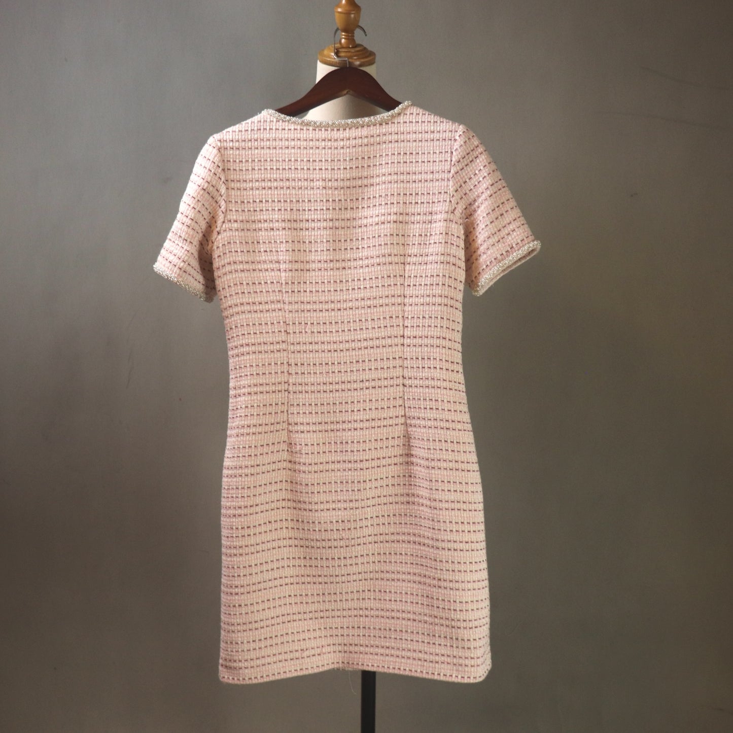 Back view of elegant pink tweed custom dress, structured feminine silhouette available in any size and length