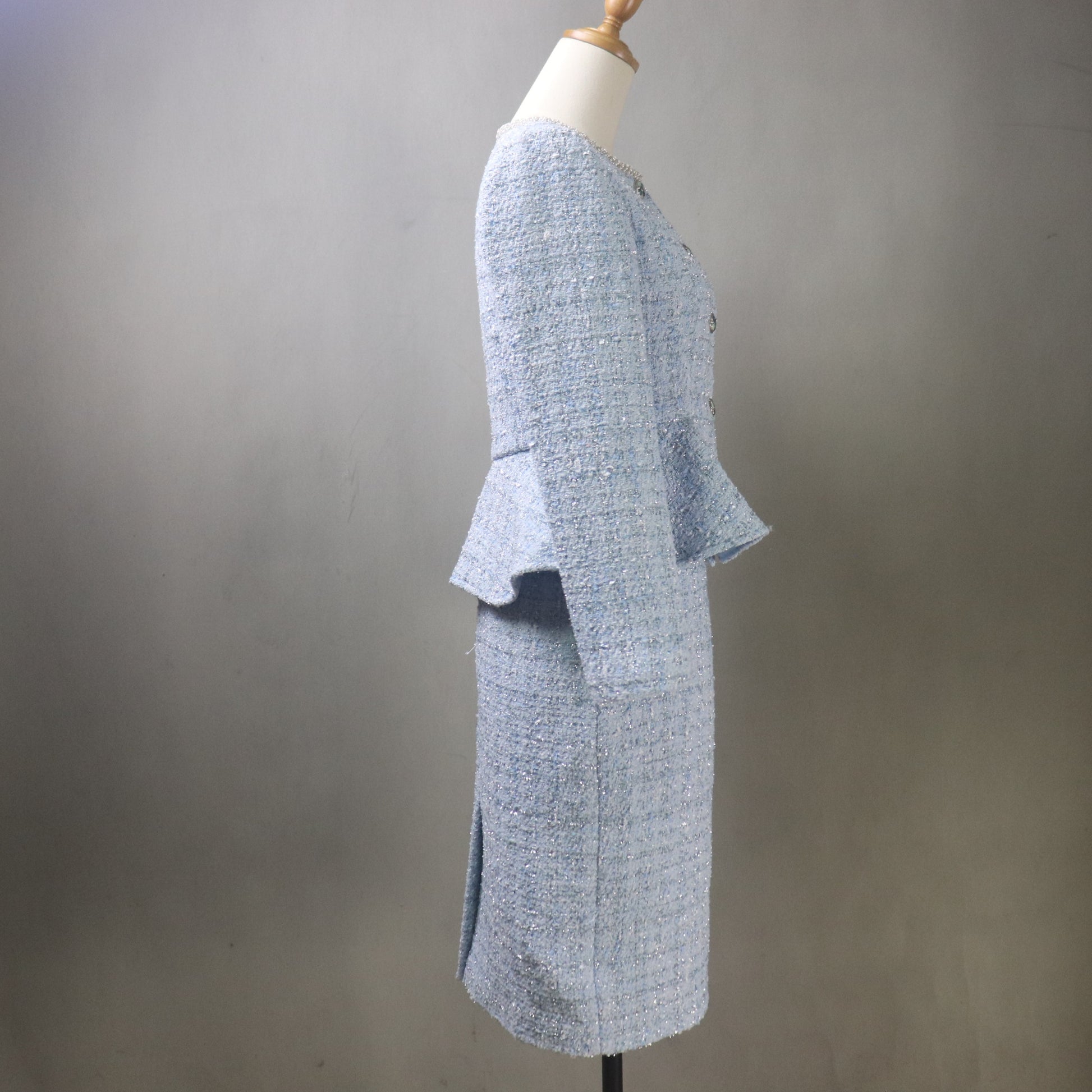 Mannequin wearing a textured gray outfit against a plain background