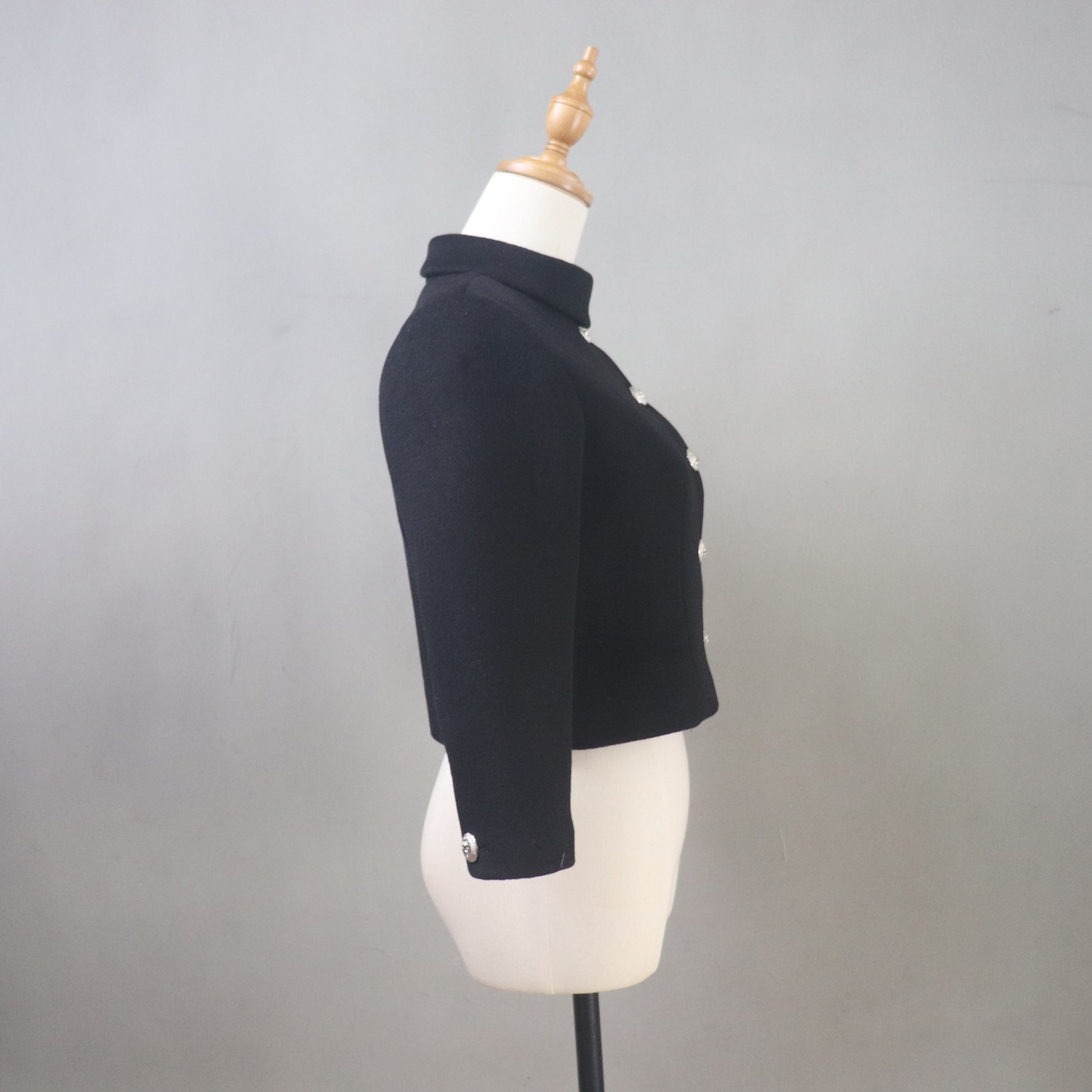 Black jacket on a mannequin against a gray background