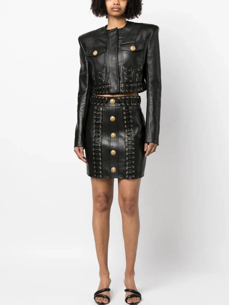 Step into the spotlight with our Women's Fitted Faux Leather Golden Buttons Straps Short Crop Jacket + Mini Skirt Suit in sleek black, perfect for pop concerts and evening events. This edgy ensemble combines the allure of faux leather with golden buttons and stylish straps, creating a captivating look that's both bold and glamorous. The fitted crop jacket exudes a biker-chic vibe, making it an ideal choice for those who crave a touch of rebellion in their fashion. 