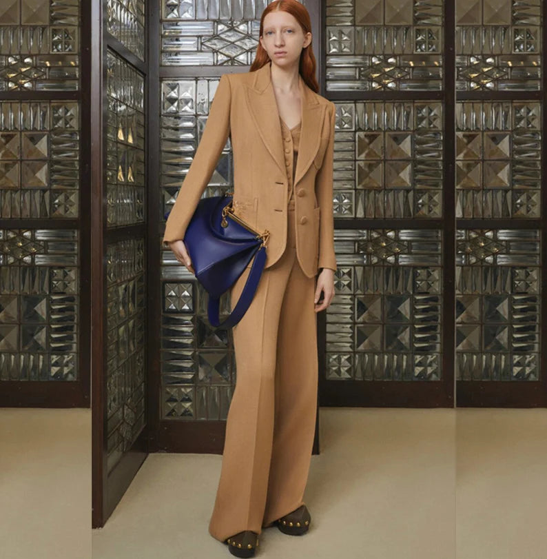The combination of mid-high rise flare trousers and a women's luxury light brown floral embroidered blazer creates a unique and eye-catching suit that is perfect for a variety of occasions. The flare trousers add a trendy touch to the suit, while the embroidered blazer adds an elegant and sophisticated look.