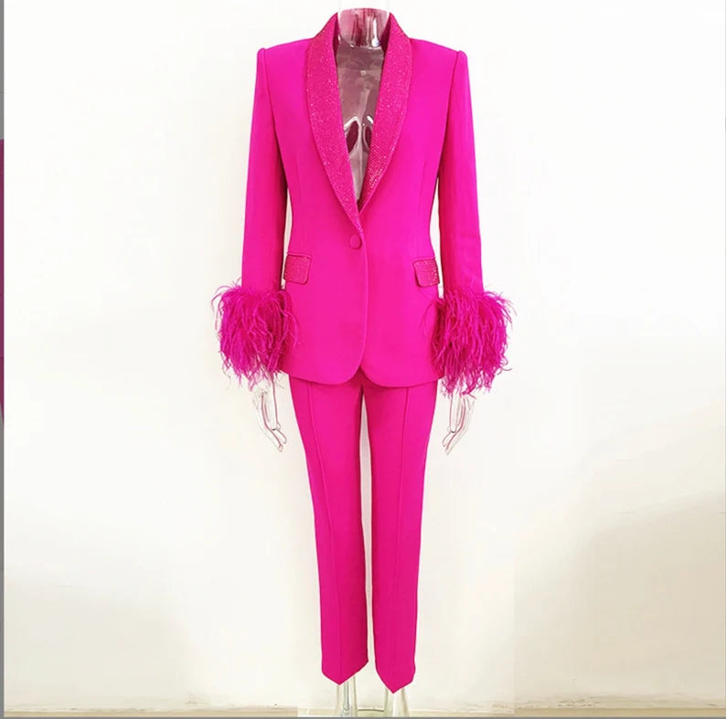 This is a beautiful and stylish matching set, perfect for a wedding or any special occasion. The outfit consists of a blazer and trousers. Overall, this suit is a stunning combination of comfort, style, and sophistication. The velvet pink cuffs with feather and sequin details add a touch of glamour, making it a standout choice for any event where you want to look chic and refined.