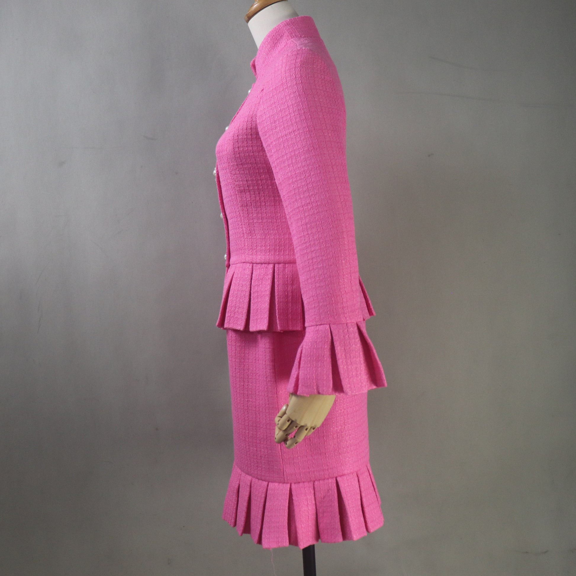 Vintage style pink skirt suit for wedding guests with structured jacket and matching custom-made skirt.
