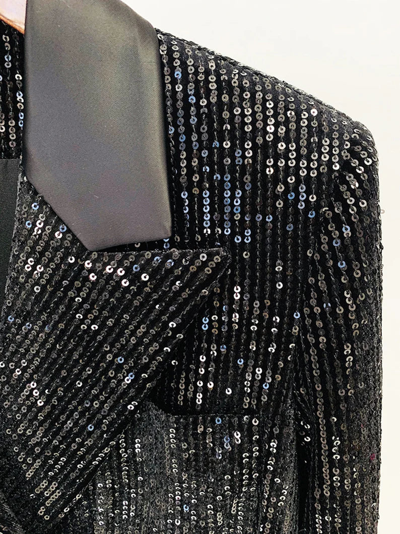 This modern, party-ready ensemble from our Women's Collection is sure to make an entrance. Crafted from a high-quality black sequinned fabric, it features a flattering, fitted blazer and mid-high rise flare trousers suited for any special event. A timeless wardrobe staple that you'll love season after season.