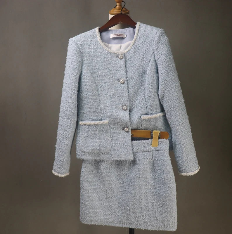 A women's light blue tweed suit tailored to order is the height of refined sophistication. Tweed, which is well-known for its robustness and timeless appeal, receives a feminine update in a light blue colour that is ideal for bringing a little sophistication into any outfit. The entire comfort and attractiveness of the suit are improved by custom tailoring, which guarantees an impeccable fit.