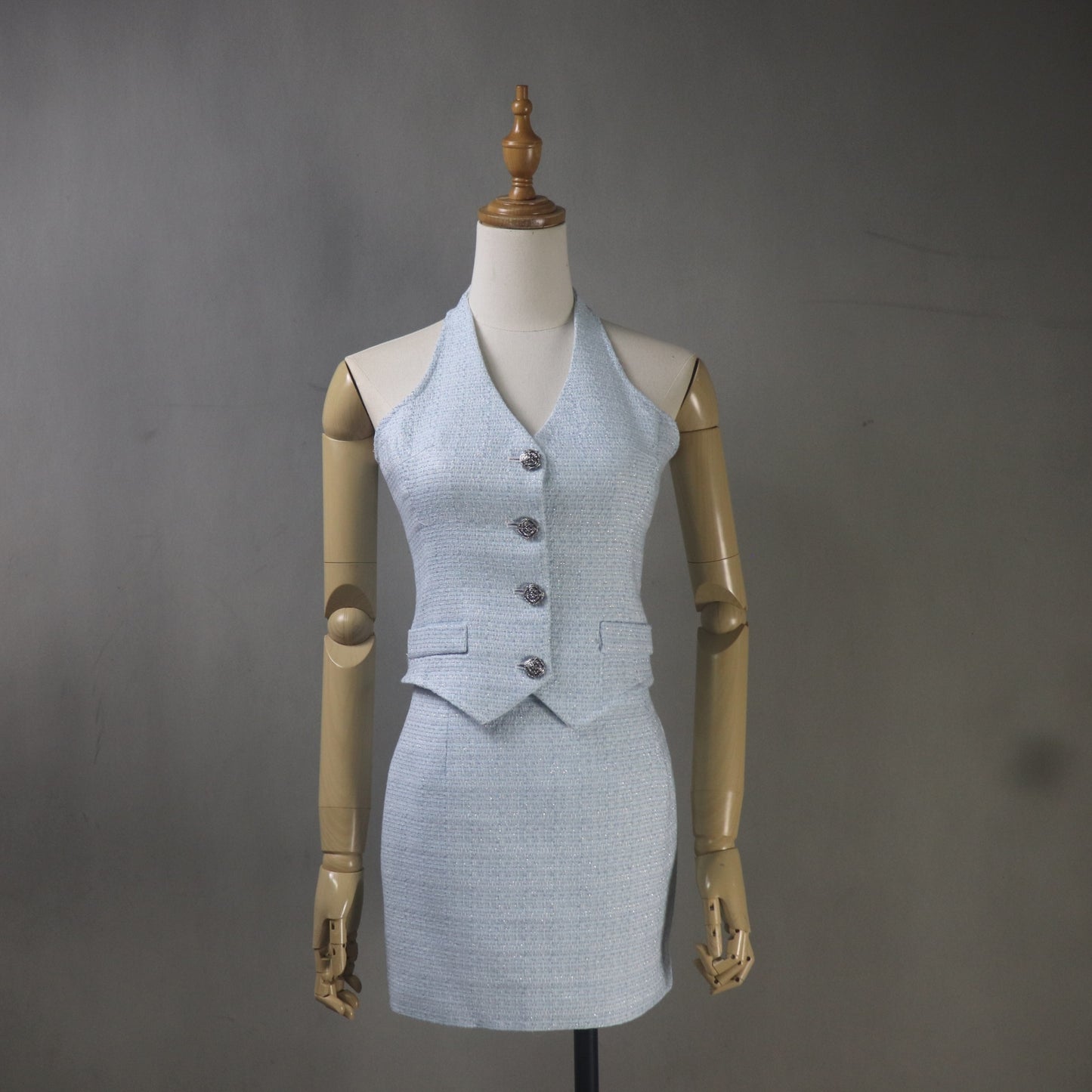 Light blue suit on a mannequin against a gray background