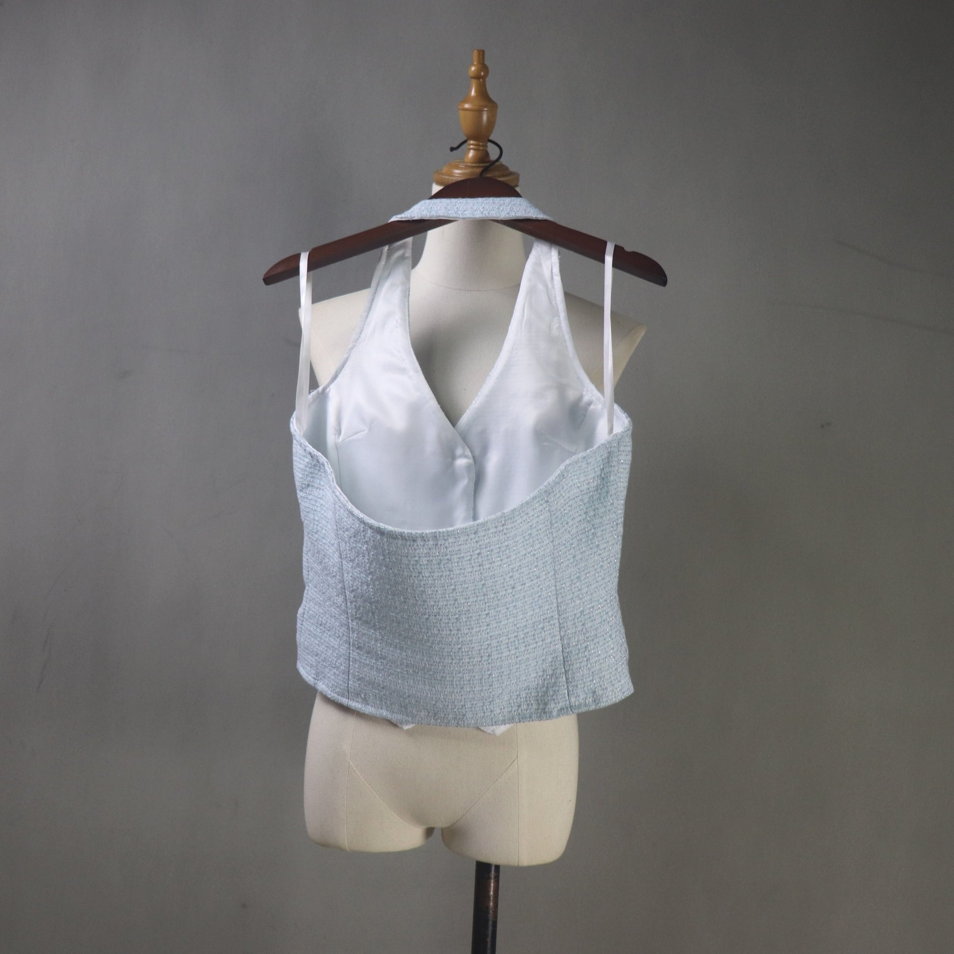 Light blue textured tank top on a mannequin with a plain background