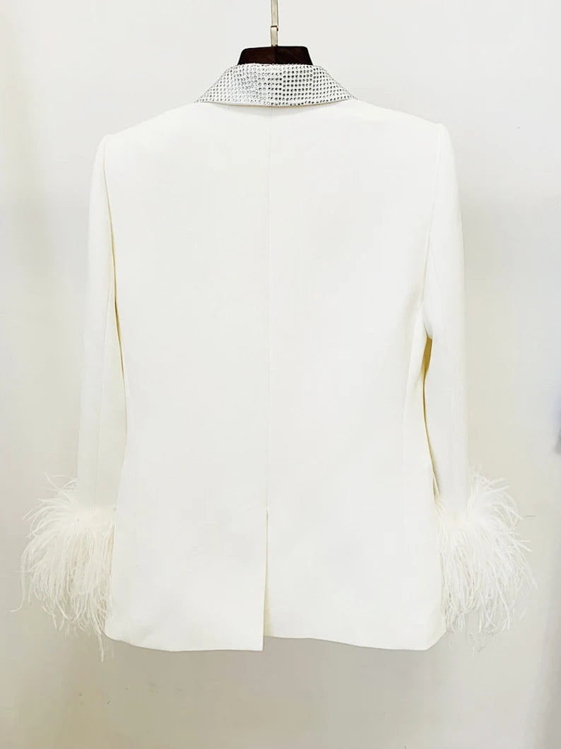 Dazzle in sophistication with our White Faux Fur Cuffs Blazer Coat, a statement piece featuring luxurious velvet cuffs, a feather-sequined shawl collar, and an alluring silhouette. This blazer effortlessly pairs with Mid-High Rise Pencil Trousers to create a stunning suit ensemble. Elevate your style with keywords like opulence, glamour, elegance, feathered accents, sequin embellishments, chic ensemble, sophisticated blazer, faux fur details, velvet cuffs, and timeless appeal. 