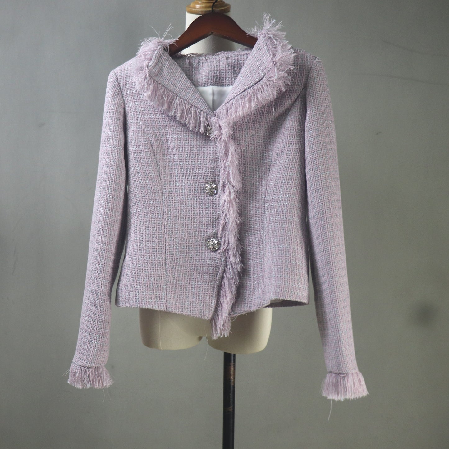 Light purple textured jacket on a mannequin against a plain background