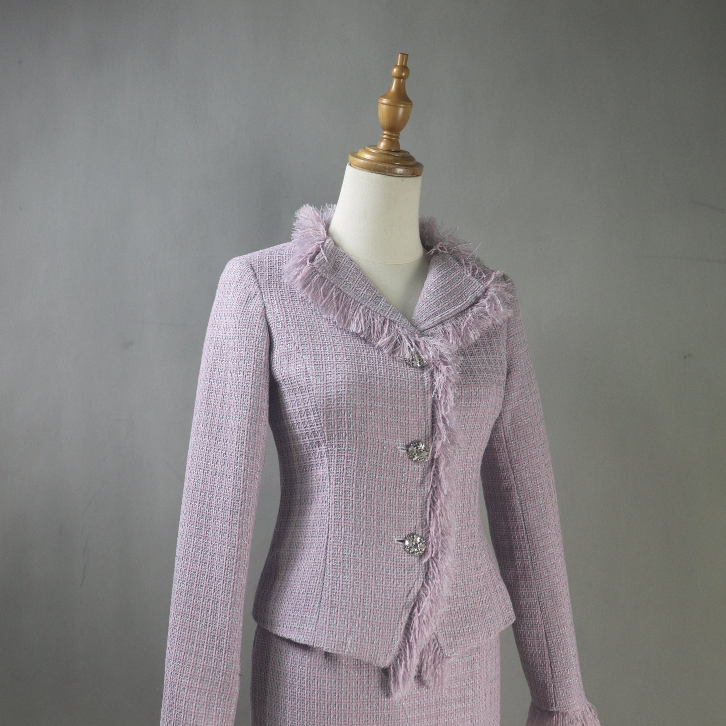 Purple textured suit on a mannequin against a gray background