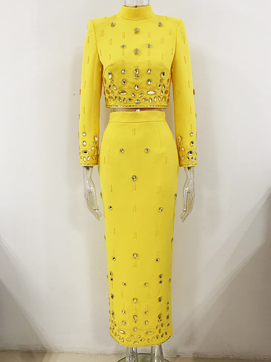 The suit is a dazzling and stylish ensemble that is perfect for making a statement at any special occasion during the spring and summer. The set features a crop top with intricate jewellery embellishments, adding a touch of glamour and luxury. The matching long skirt creates a harmonious and elegant look.