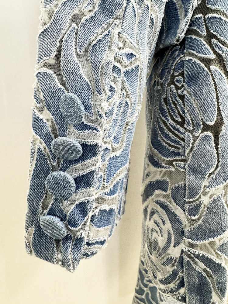 Close up of women's floral denim blazer showing rose embossed texture, lapel collar, and premium denim fabric