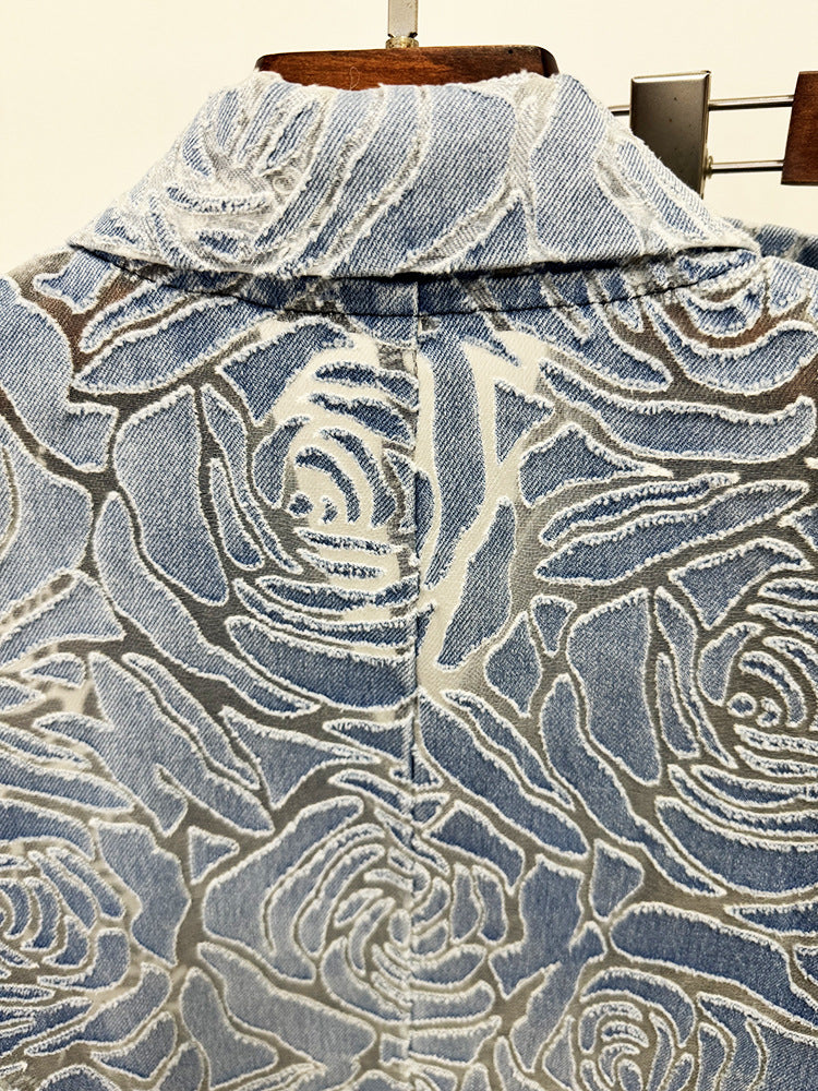 Close-up of a denim shirt with floral pattern on a hanger
