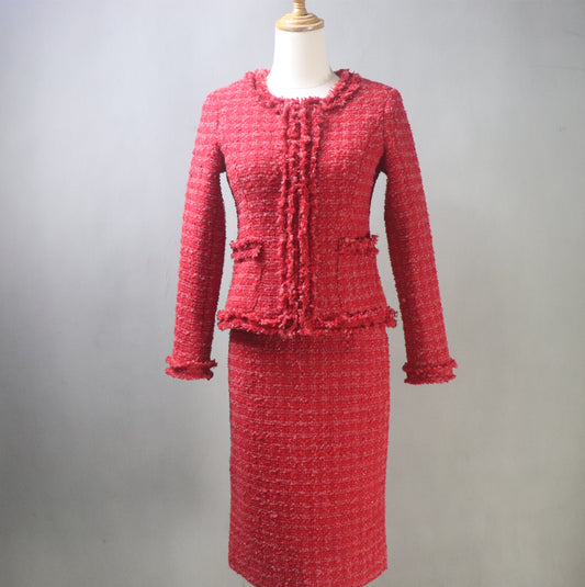 Front view of bespoke red tweed suit on mannequin – short tailored jacket and high-waisted skirt
