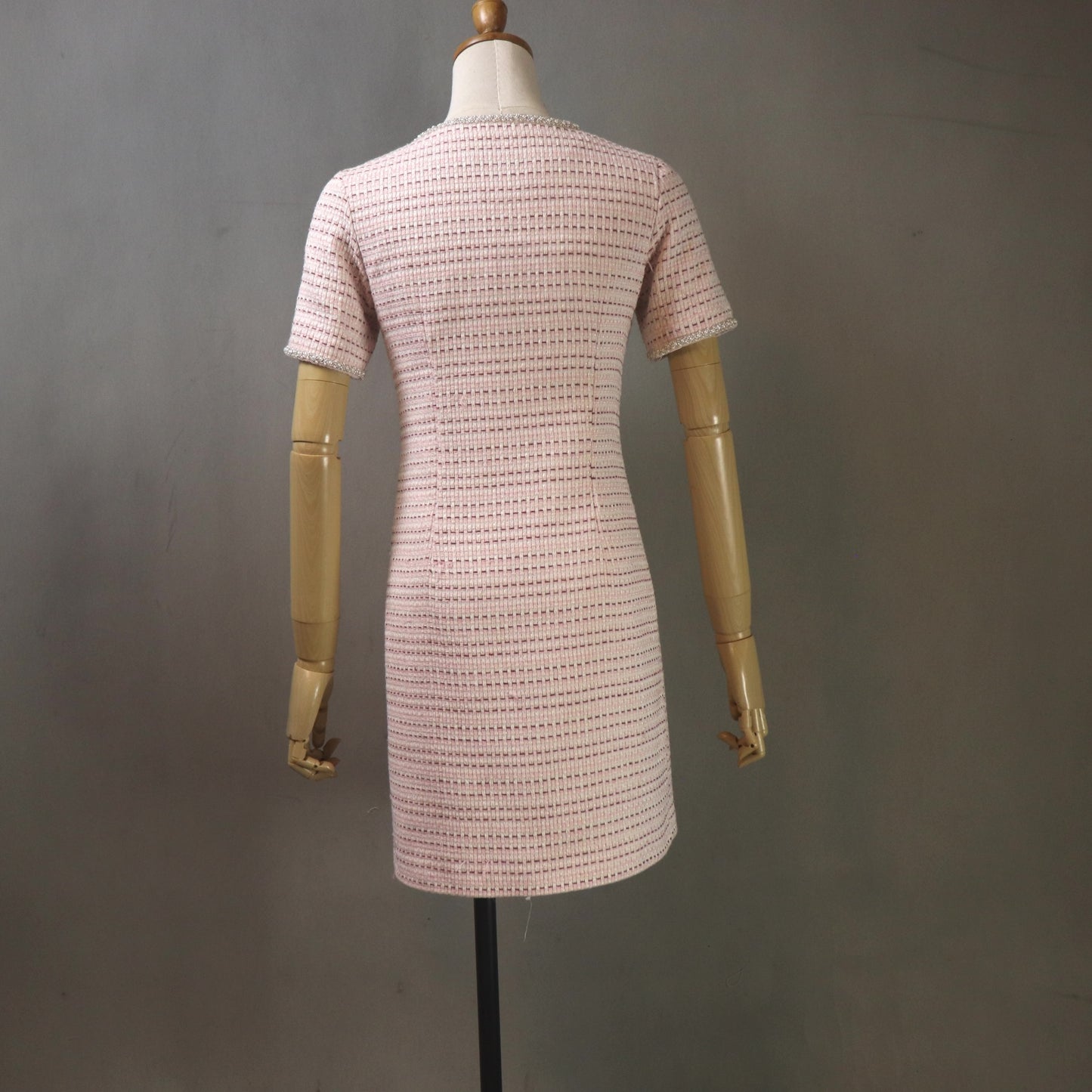 Back view of elegant pink tweed custom dress, structured feminine silhouette available in any size and length