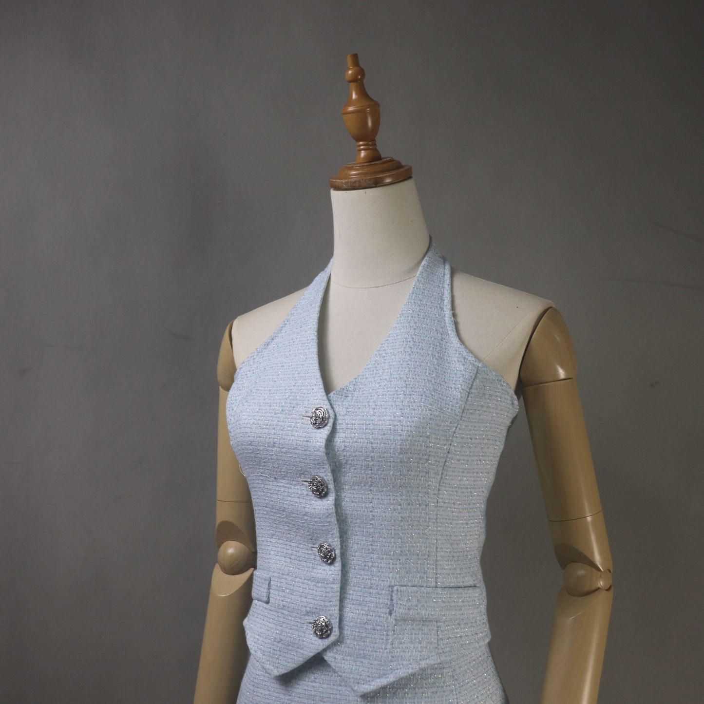 Light blue textured vest on a mannequin against a gray background