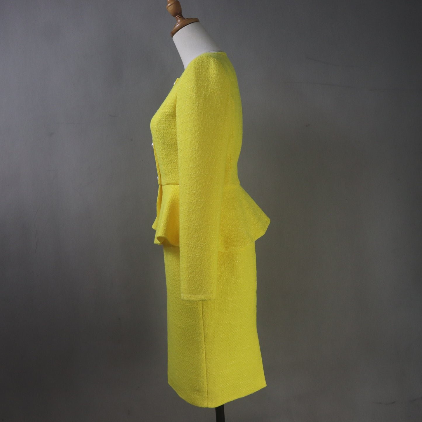 Elegant yellow formal suit for women with structured peplum waist and classic pencil skirt silhouette, perfect for weddings
