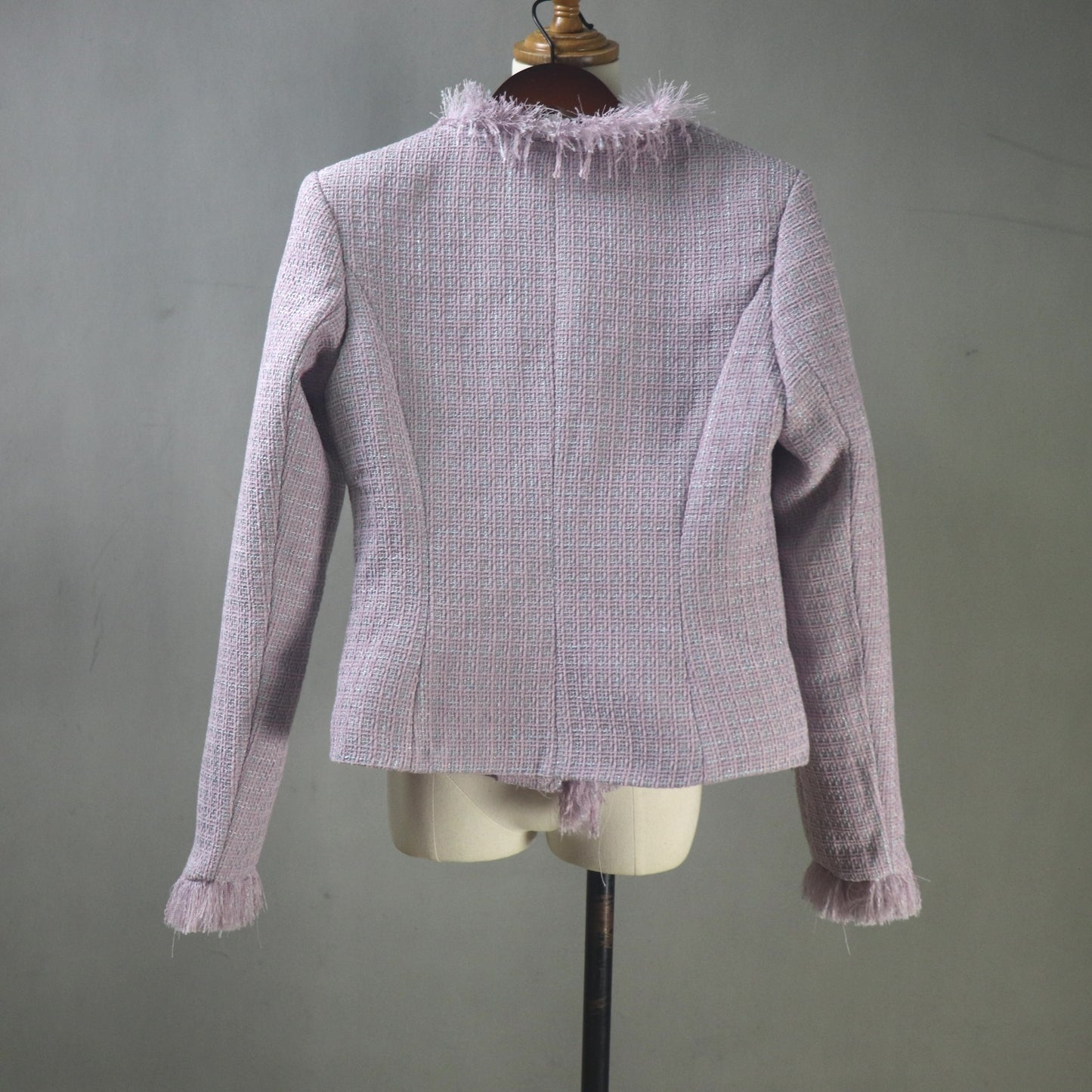 Light purple textured jacket on a mannequin against a gray background