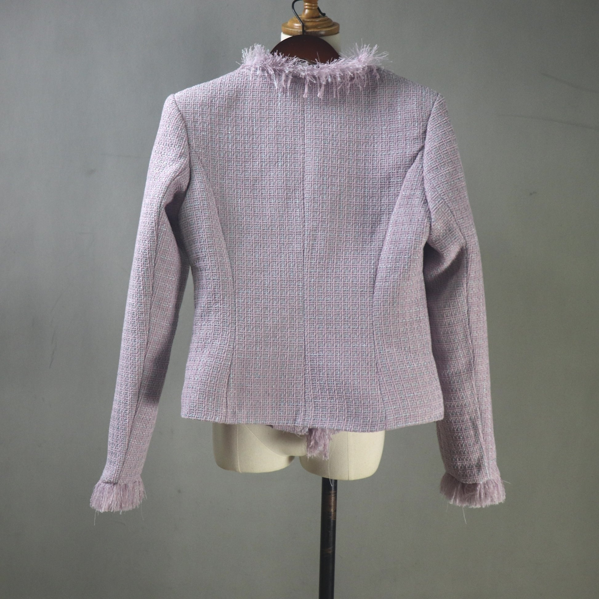 Light purple textured jacket on a mannequin against a gray background