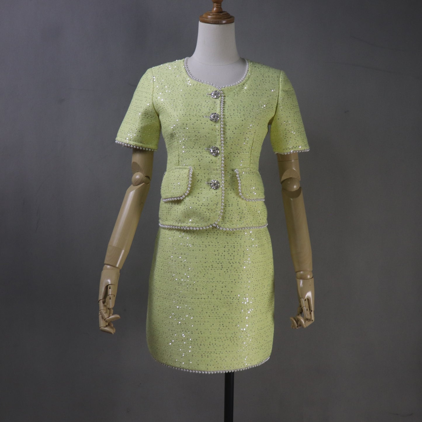 yellow dress on a mannequin against a gray background