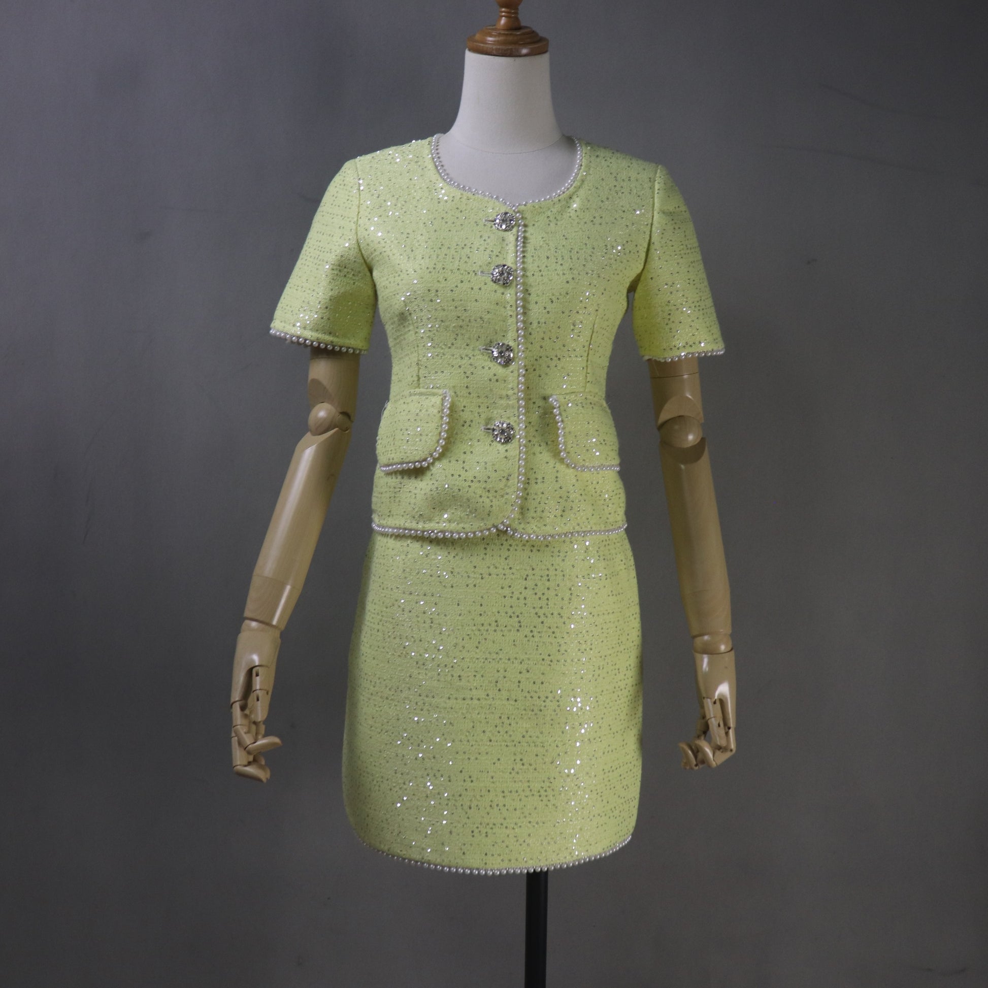 yellow dress on a mannequin against a gray background